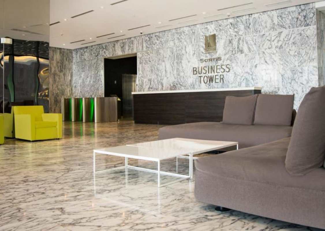 Elegant marble lobby with seating and security in Sortis Business Tower Panama City