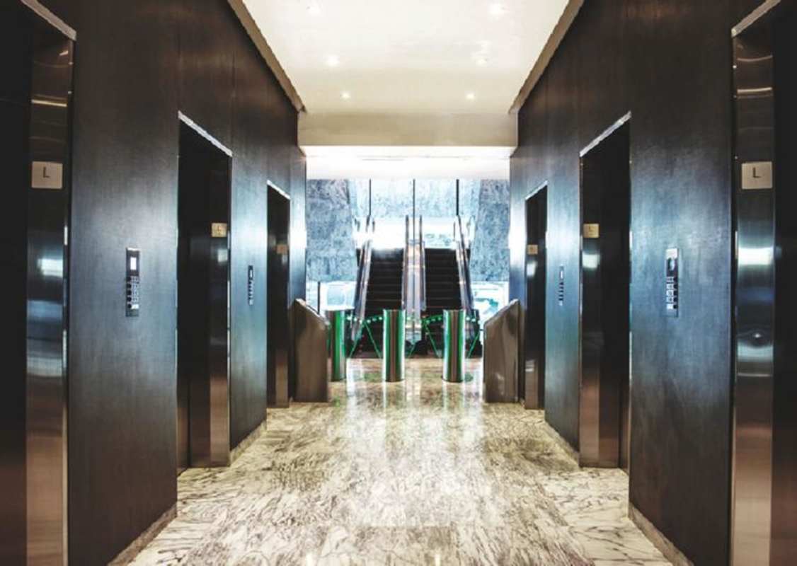 Modern elevator lobby with escalators and marble floors in Sortis Business Tower Panama