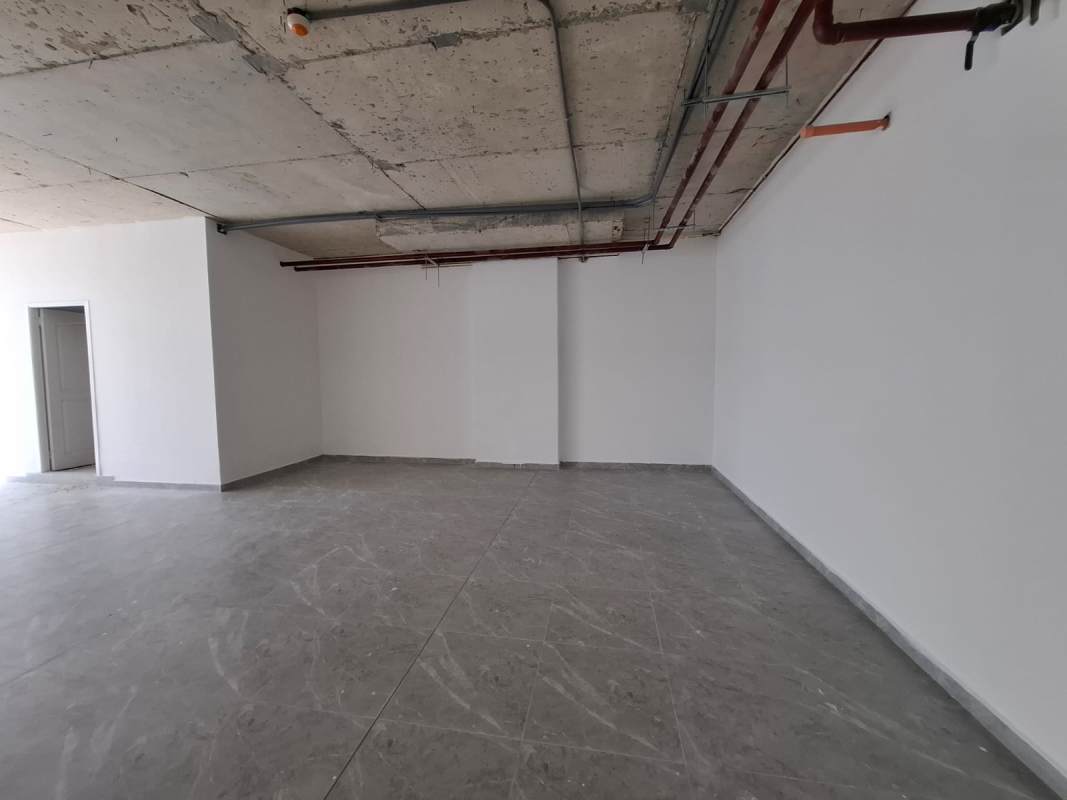 Unfinished office interior with exposed concrete ceiling at Sortis Business Tower Obarrio