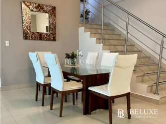 Dining space with glass table and mirror, modern staircase, in PH River Valley Panama Pacifico