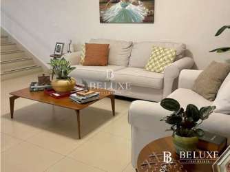 Living room with white sofas, tiled floors, large windows in PH River Valley Panama Pacifico