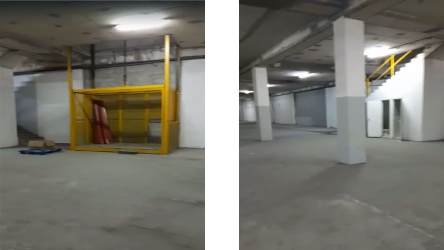 Warehouse interior with freight elevator, metal stairs and concrete flooring in Zona Libre Colon Panama