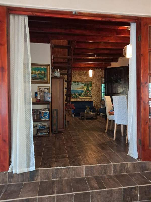 Country home porch terrace with wooden beams overlooking nature in Cerro Azul Panama