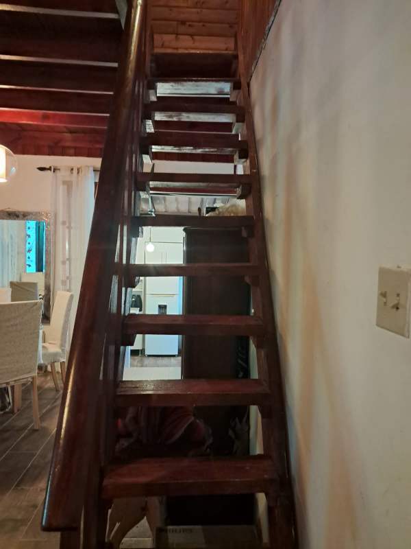 Open living and dining room with wood ceilings, stone accents in country home Panama