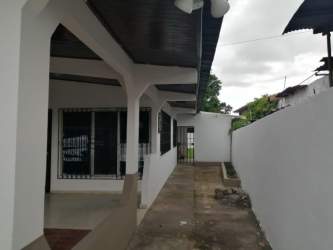 Covered porch with columns and fenced lot commercial house in David downtown