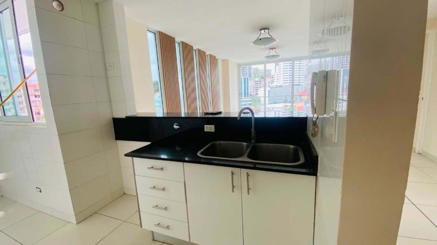 Modern kitchen with black granite countertop and double sink Bella Vista apartment Panama City