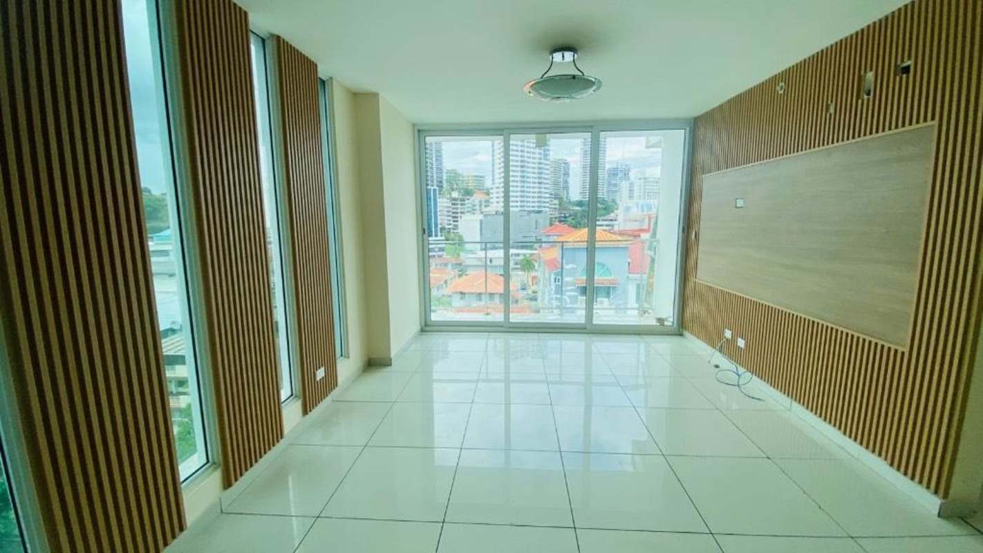 Modern empty living room with city view through floor-to-ceiling glass Bella Vista apartment Panama City