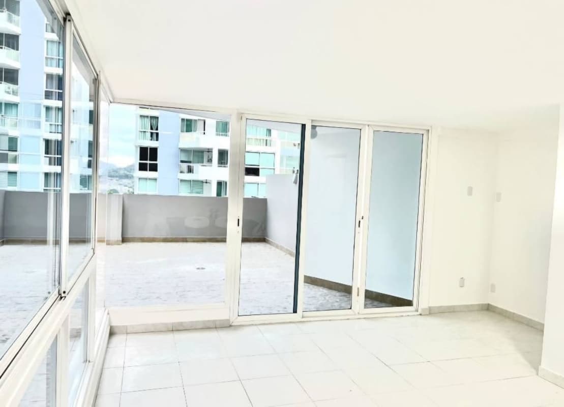 Modern living room with large sliding glass doors opening to terrace city views Edison Park Panama City