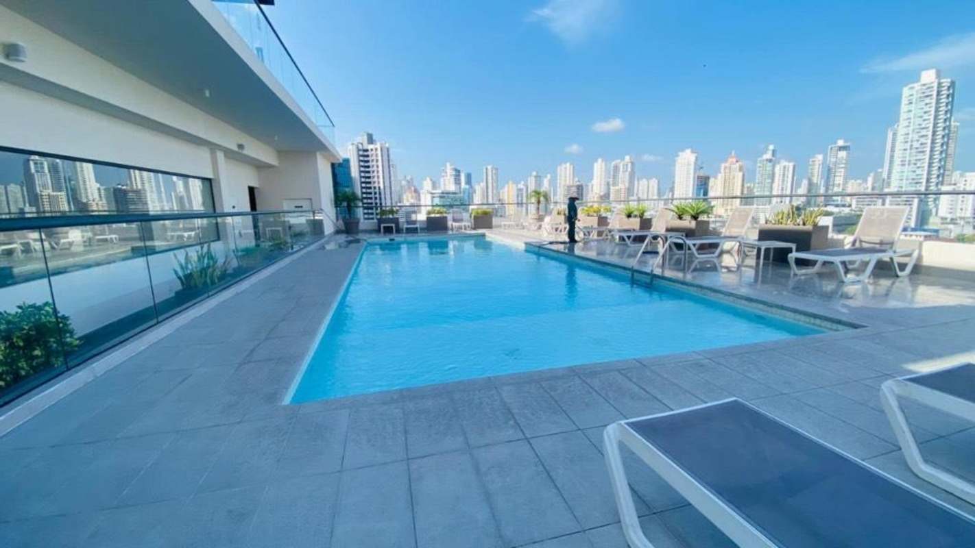 Bedroom with bed, AC, large window and ocean view in furnished apartment for rent Panama