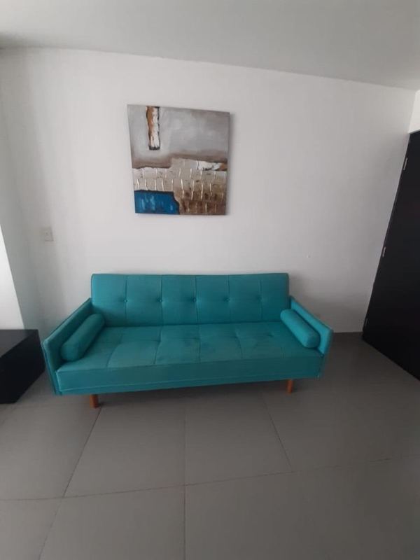 Living room area with turquoise sofa and abstract art PH BICSA Tower Panama