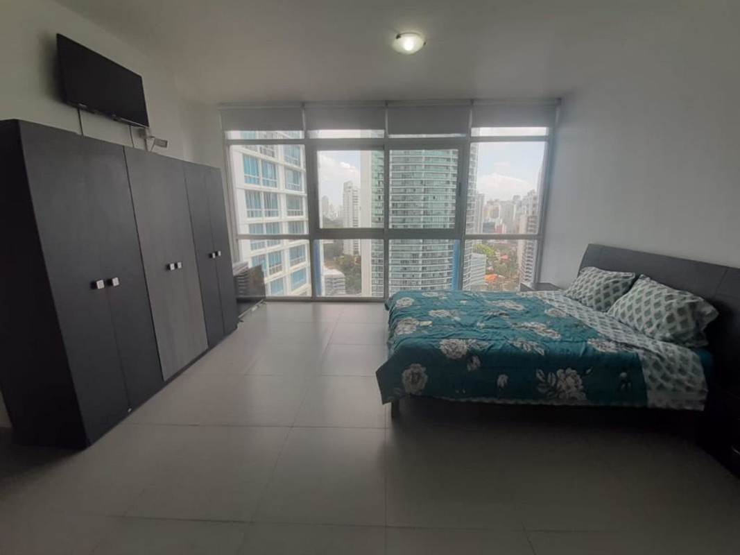 Modern bedroom with city views, black wardrobe, floral bedding, PH BICSA Tower on Avenida Balboa Panama