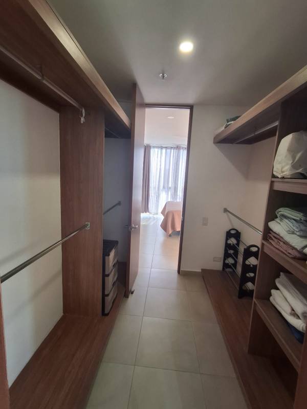 Spacious walk-in closet with built-in wooden organizers PH Portoalegre Panama