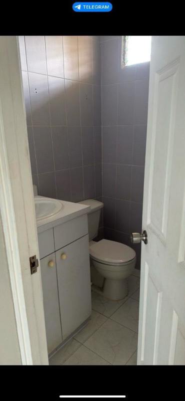 Bright living room with tiled floors, window and sliding door Villa de las Fuentes Panama