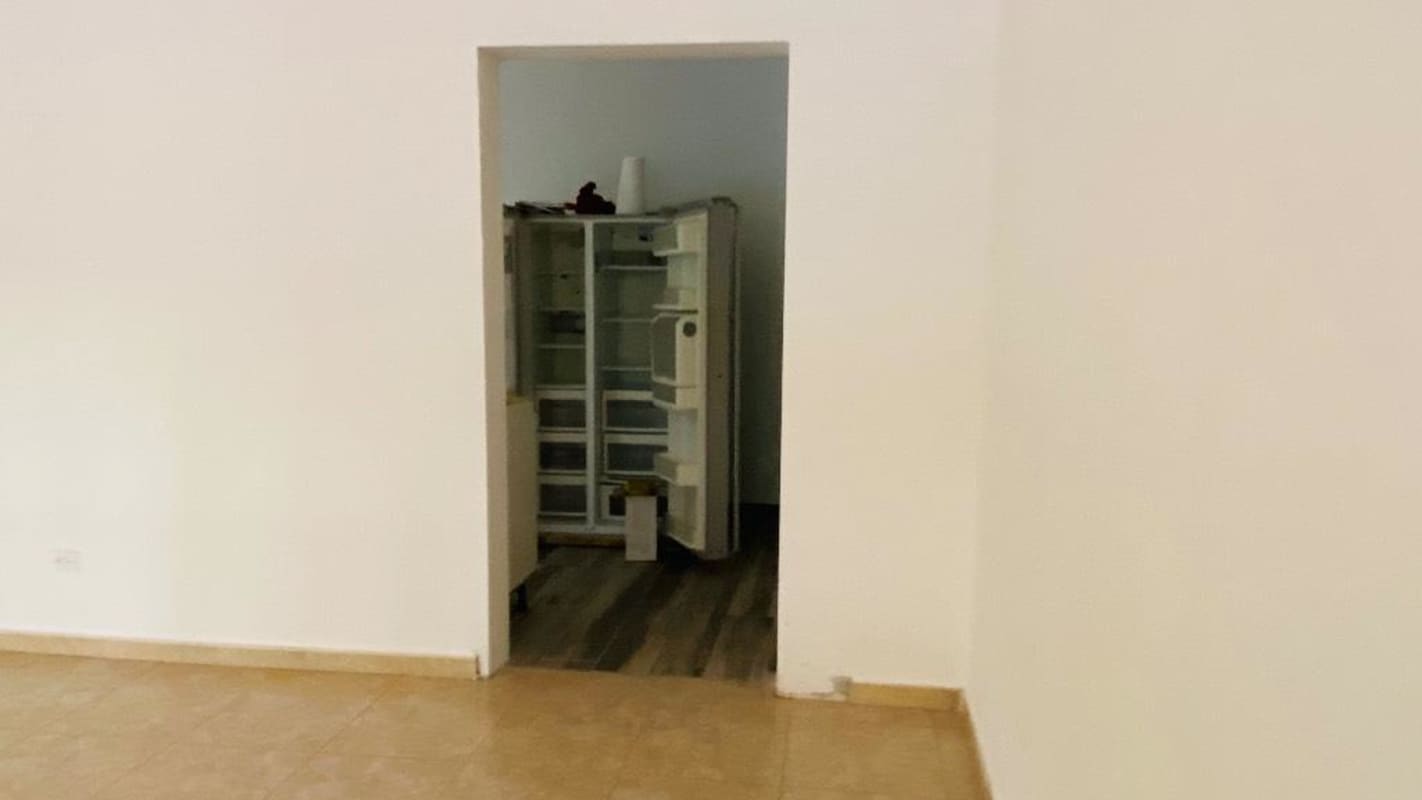 Spacious entrance hall with wrought iron staircase chandelier in Costa del Este home for rent