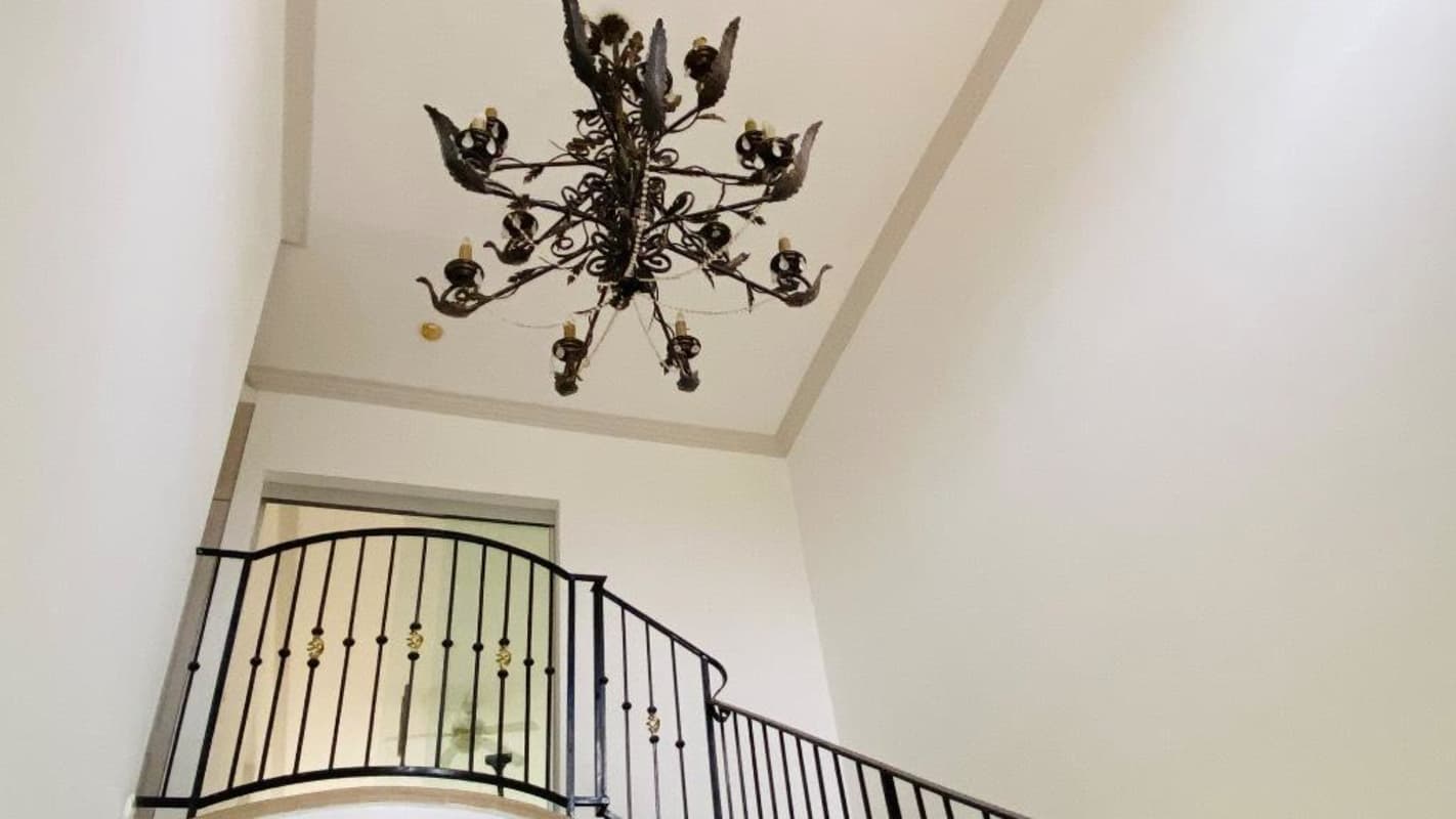 High ceiling staircase with iron railing and chandelier Costa del Este