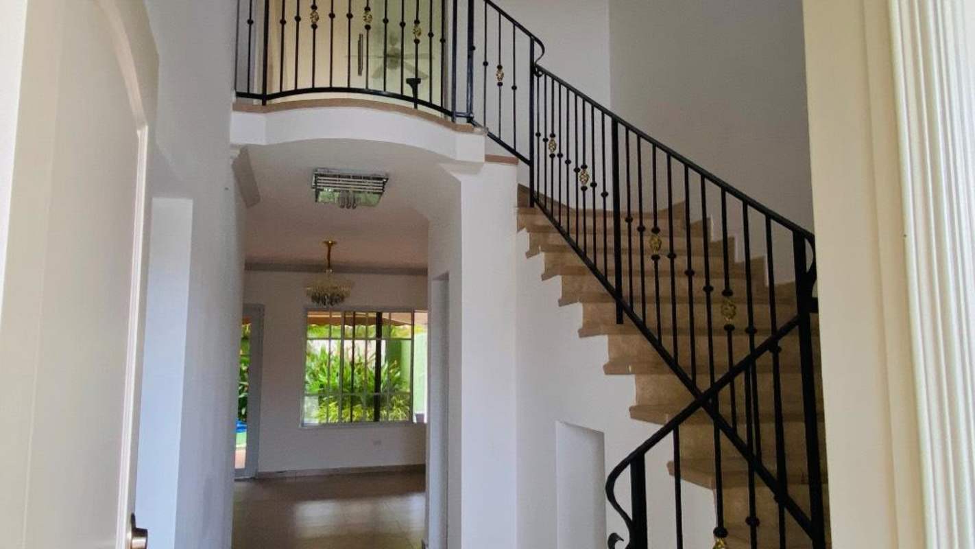 Elegant entrance with high ceiling iron railing staircase Panama house