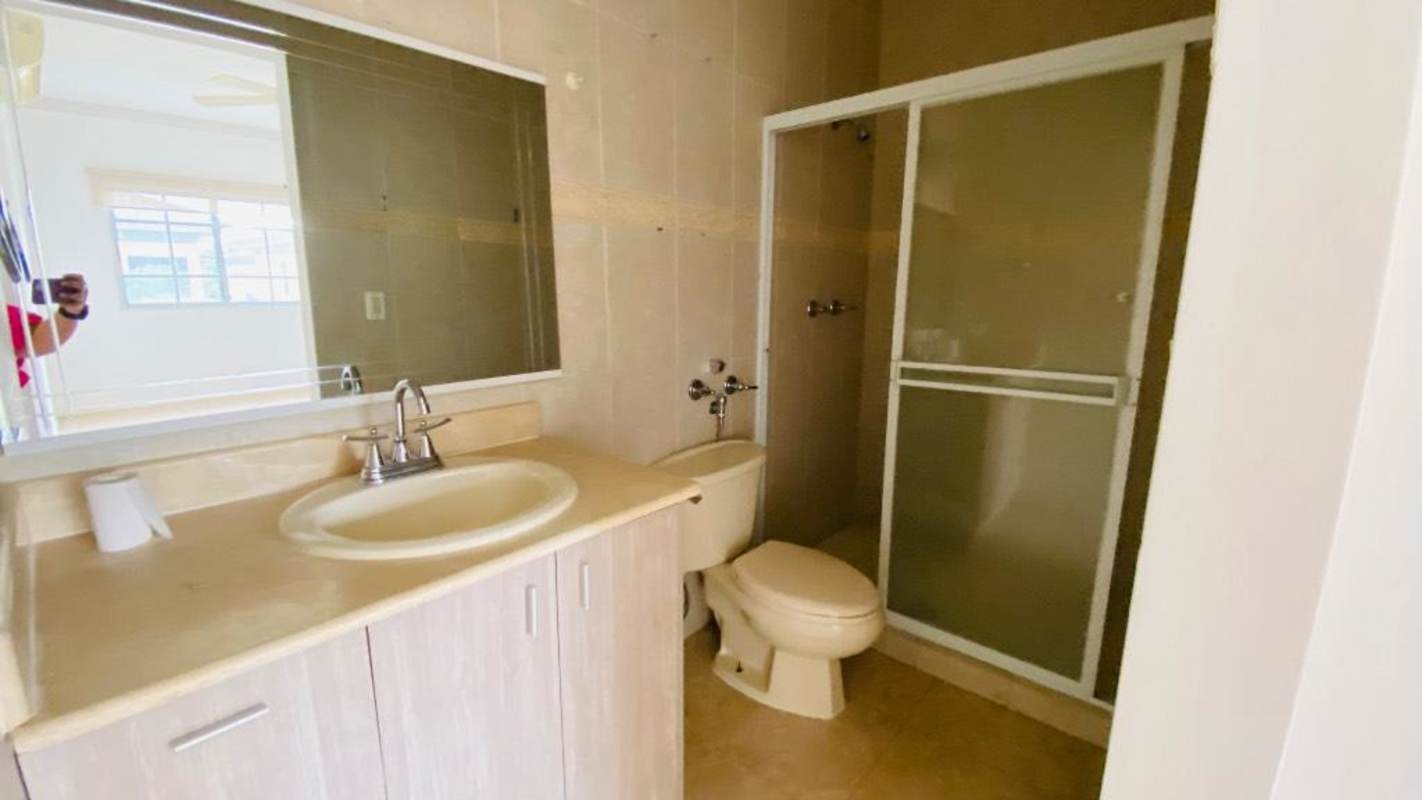 Contemporary bathroom with beige tiles, glass shower and vanity in Panama rental