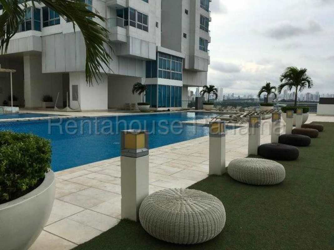 Living room with city view windows, white sectional sofa and dining area in PH Top Towers Costa del Este Panama