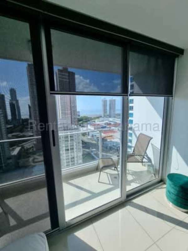 Modern living and dining space with large windows, ceiling fan, TV in PH Top Towers Costa del Este