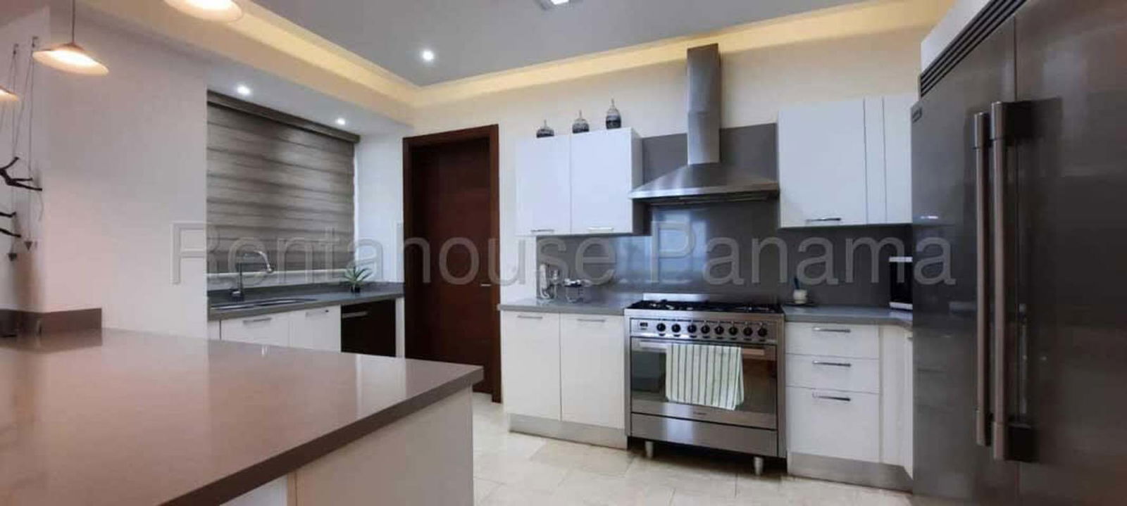 Modern bathroom with marble countertops and glass shower enclosure at PH Greenview Santa María