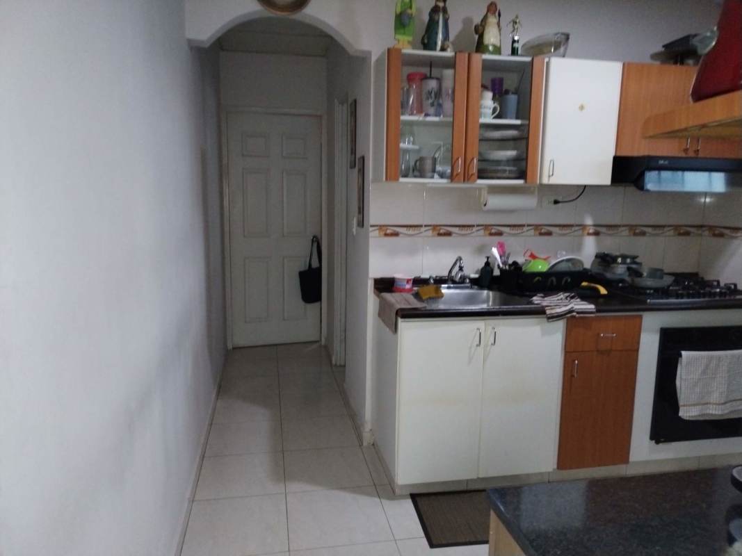 Functional bathroom with beige tiles, window, shower with curtain La Riviera Panama