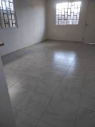 Minimalist living room with tiled floor, barred windows, natural light in Mystic City La Chorrera house for rent