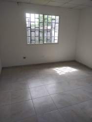 Empty room with tiled floor and window with bars in house for rent Mystic City La Chorrera Panama