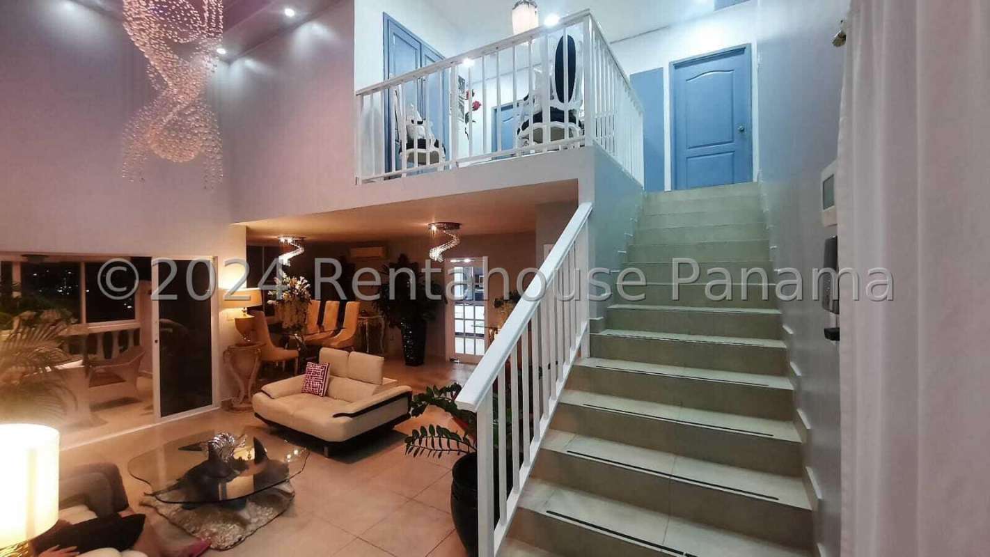 Contemporary dining and lounge area with chandeliers and glass windows Panama City
