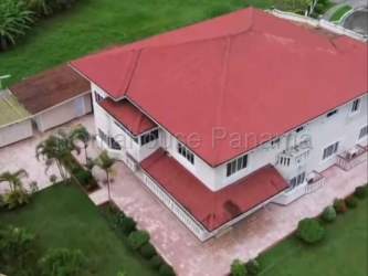 Colonial mansion aerial view with red roof large lawn and driveway Colón Panama