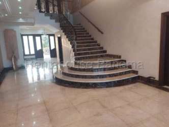 Elegant foyer with marble flooring and curved staircase luxury house for sale in Colón Panama