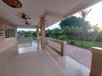 Spacious covered patio with ceiling fans overlooking tropical garden Margarita Colón Panama