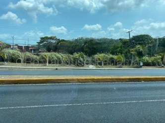 Busy street corner with restaurant and vacant commercial land for sale Colon Panama