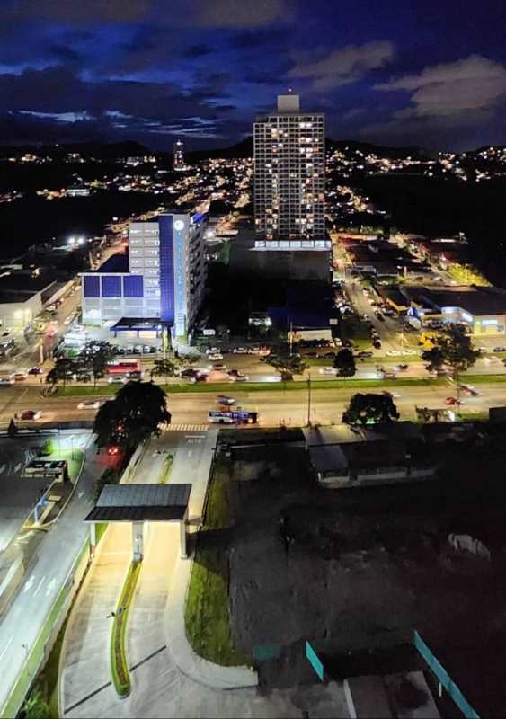Night aerial of high-rise residential building and city skyline at Condado del Rey Panama