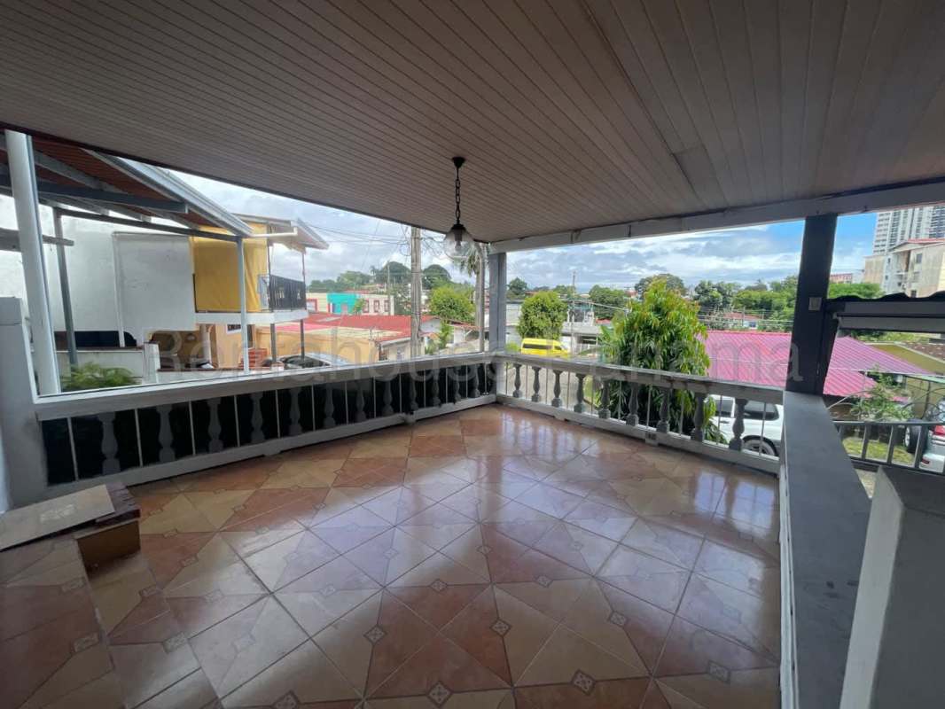 Covered tiled terrace balcony overlooking quiet neighborhood in Panama City