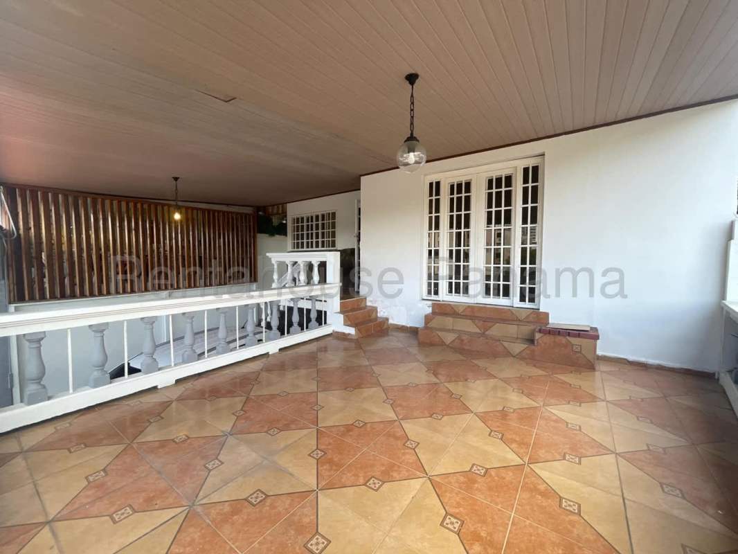 Terracotta-tiled terrace with French doors traditional home Panama City