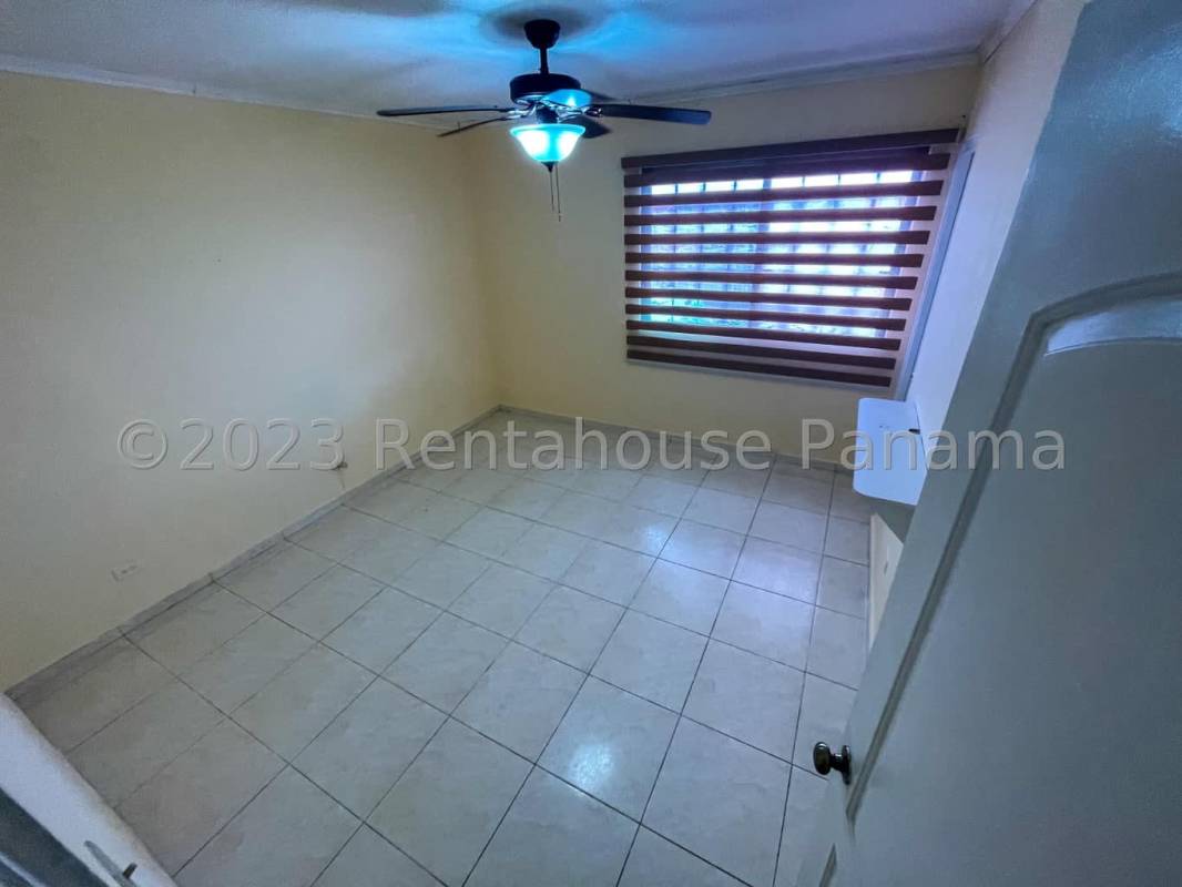 Bedroom interior with tiled floor, ceiling fan, large window and blinds in Cerro Viento Panama