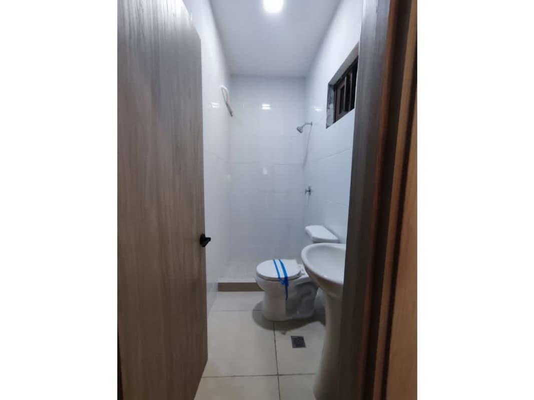 Minimalist white ceramic bathroom with walk-in shower in Costa Sur house for rent Panama