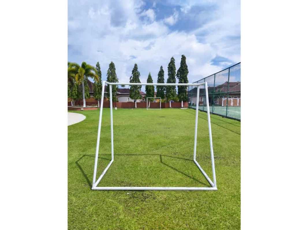 Community swimming pool surrounded by palm trees in Costa Sur gated complex Panama