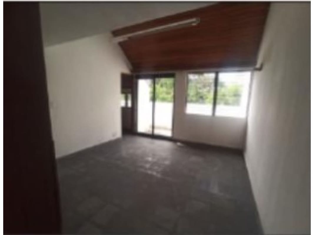Modern kitchen with high wood ceiling, dark cabinets and stone countertops in luxury Panama home