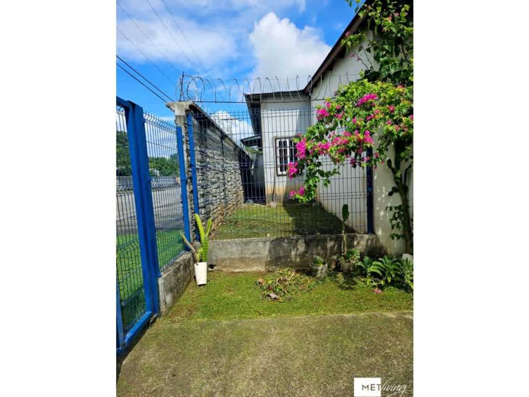 Gated house with flower garden and blue metal fence for sale Panama Altos de Azul