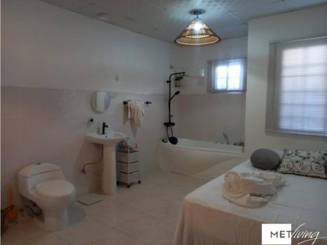 Front facade of house with parking gated area and garden for sale in Altos de Azul Pacora