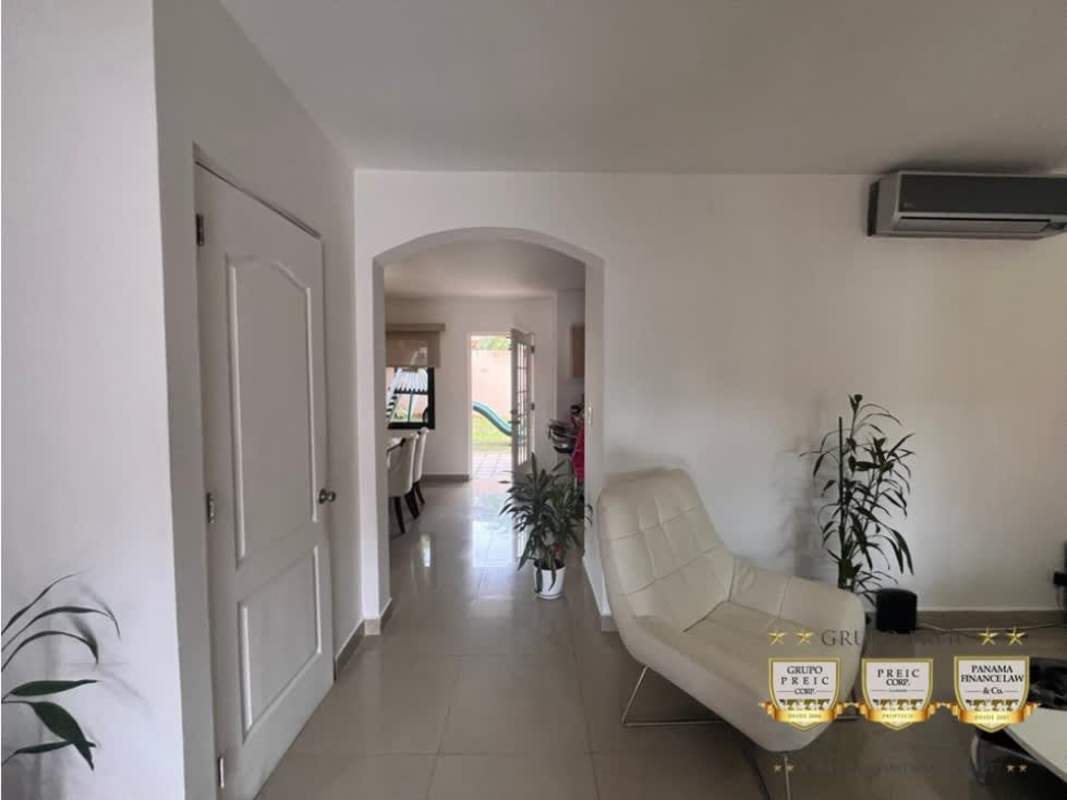 Modern dining area with marble table, pendant lights and accent wall in Versalles Panama home