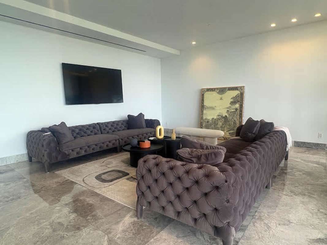 Modern living room with marble floors, natural light, city view balcony in Empire Residences Panama