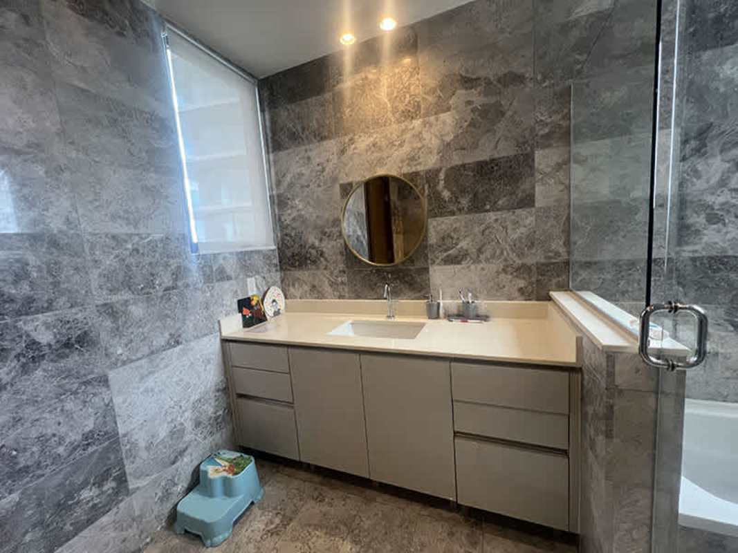 Spacious master bedroom floor-to-ceiling windows scenic views marble floors Empire Residences Panama