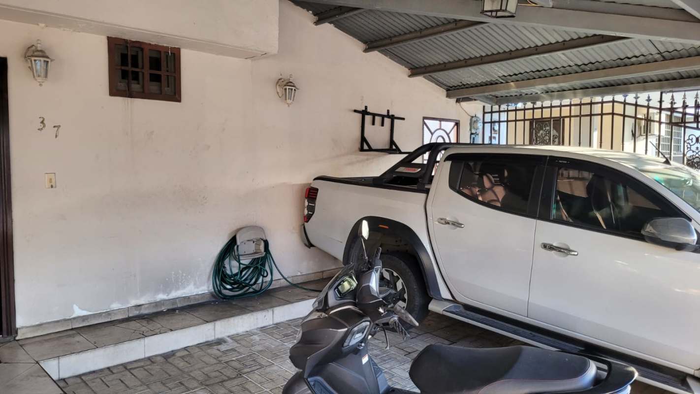 Bright living and dining area with decorative wood wall, sectional sofa in Altos de Panamá duplex