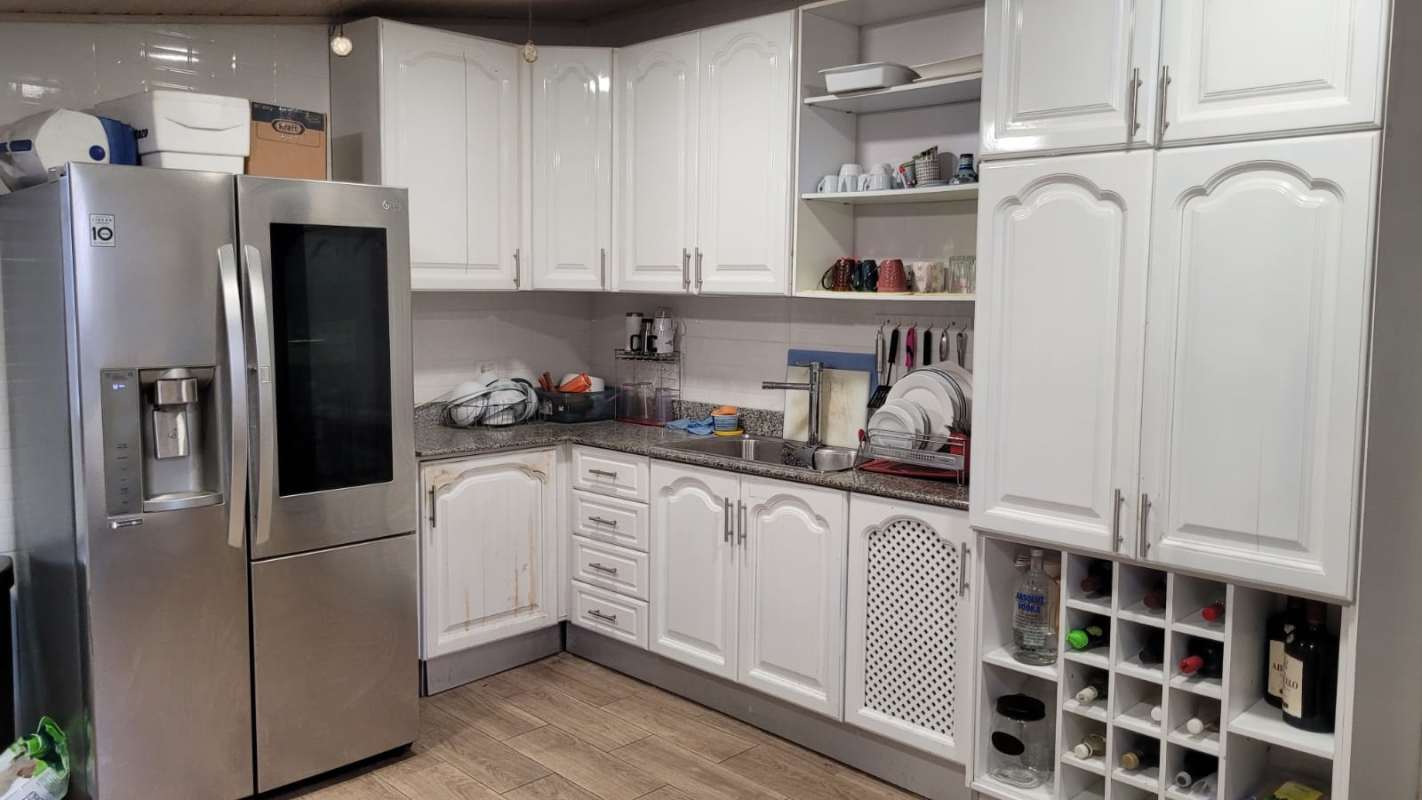 Traditional kitchen with granite, refrigerator and wine rack in Altos de Panamá rental duplex
