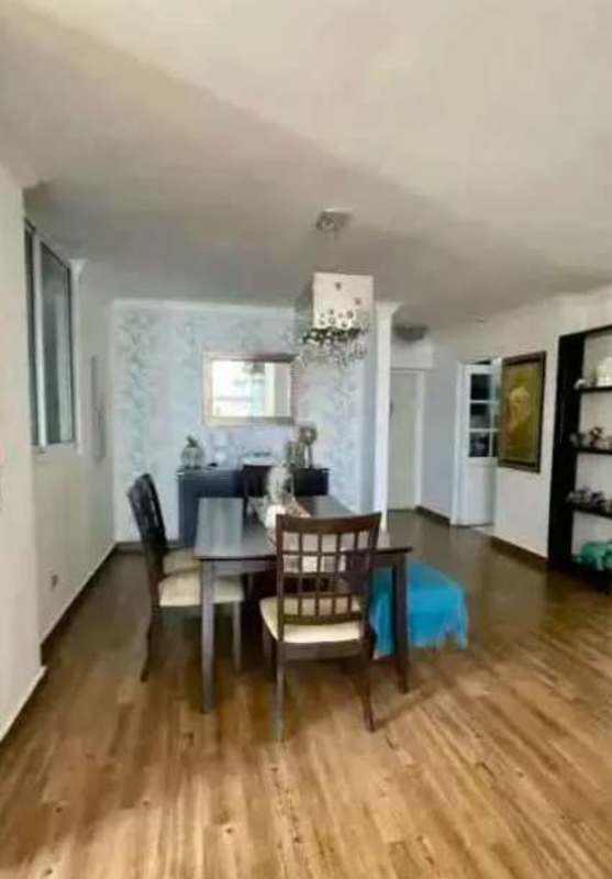 Contemporary dining space with wood floors, chandelier and wall mirror in apartment at Aurora Tower El Cangrejo