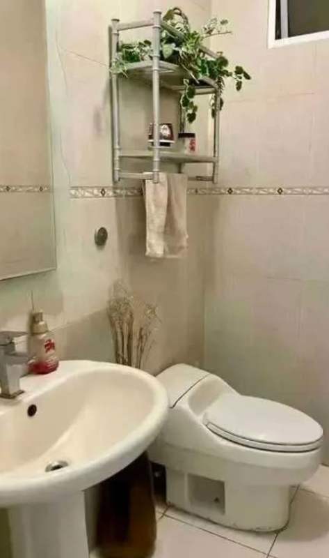 Contemporary bathroom with pedestal sink, mirror, modern toilet at Aurora Tower El Cangrejo Panama