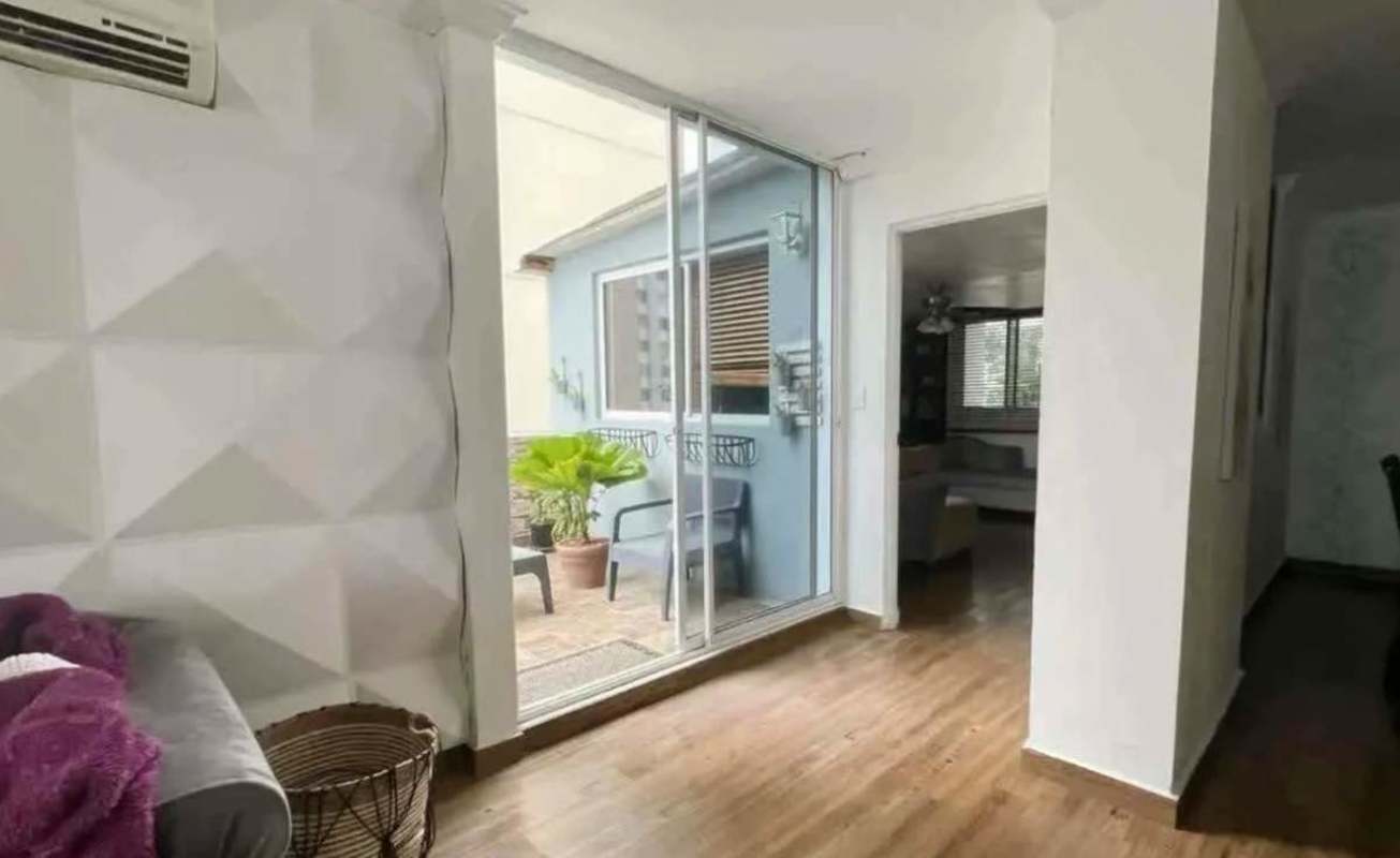 Modern galley kitchen with granite counters, stainless appliances, dark cabinetry in Aurora Tower Panama City