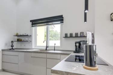 Open-plan living space with garden and pool views in San Carlos beach house